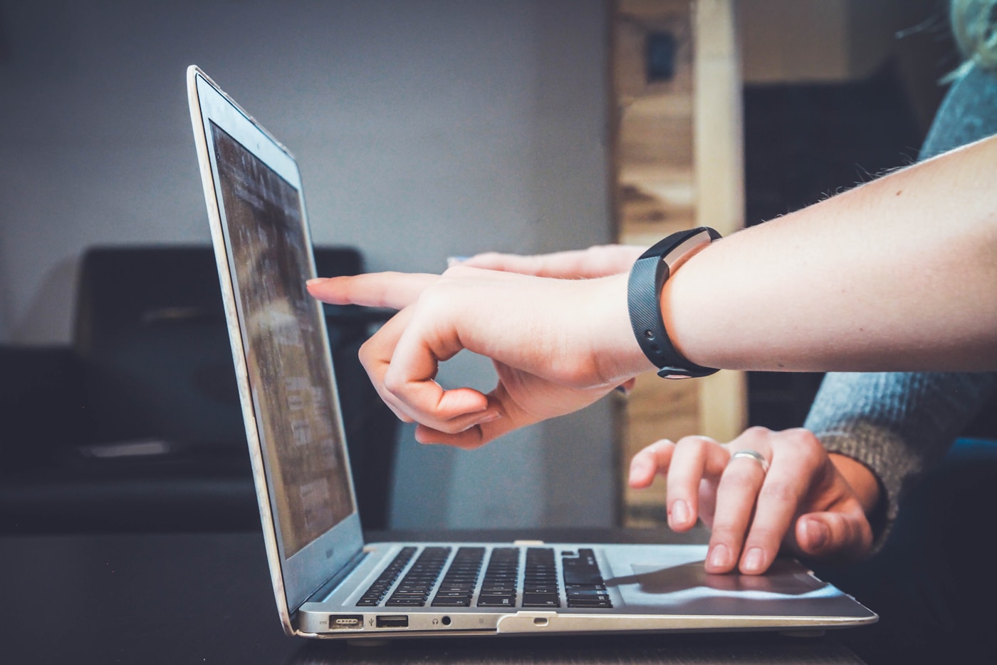 Consultant guiding a client through a laptop screen