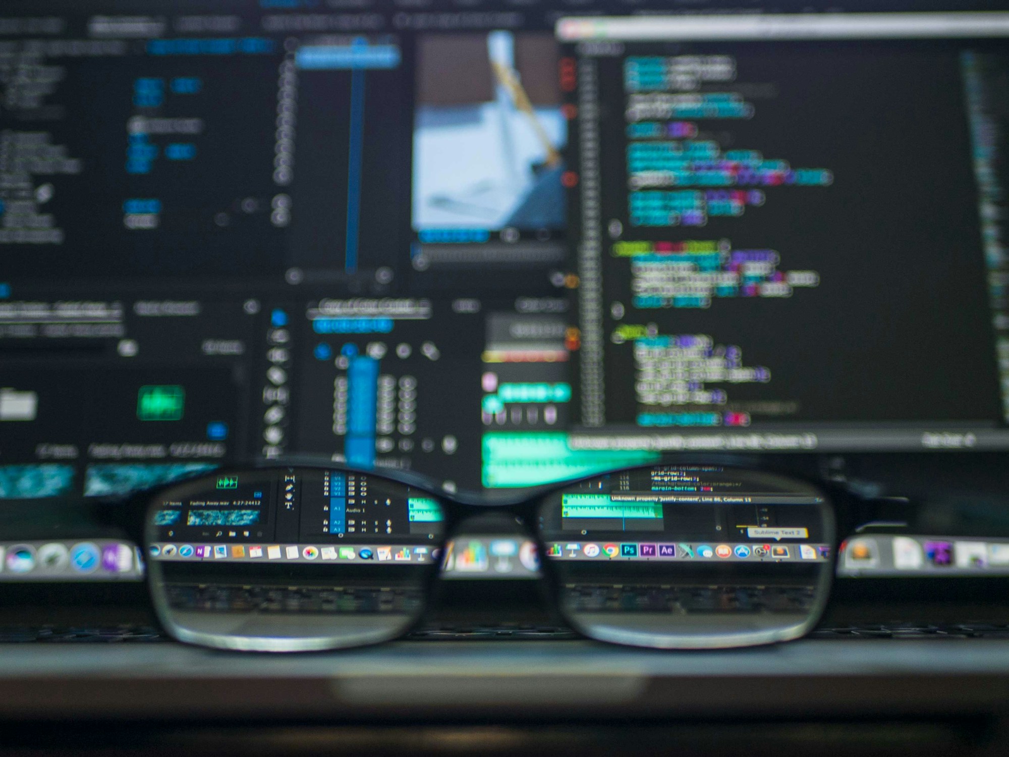 Laptop with code on screen — IT consulting workspace
