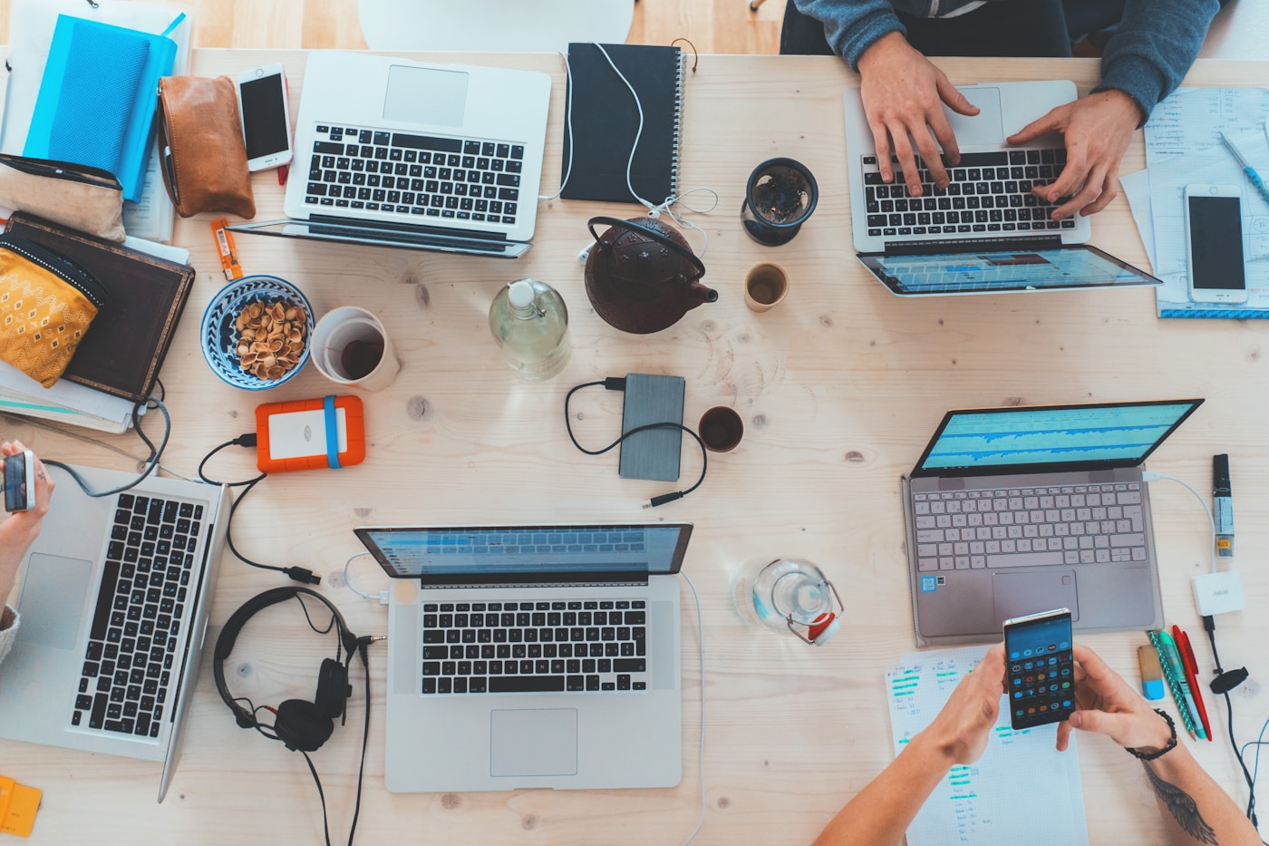 Professionals collaborating around laptops in an office
